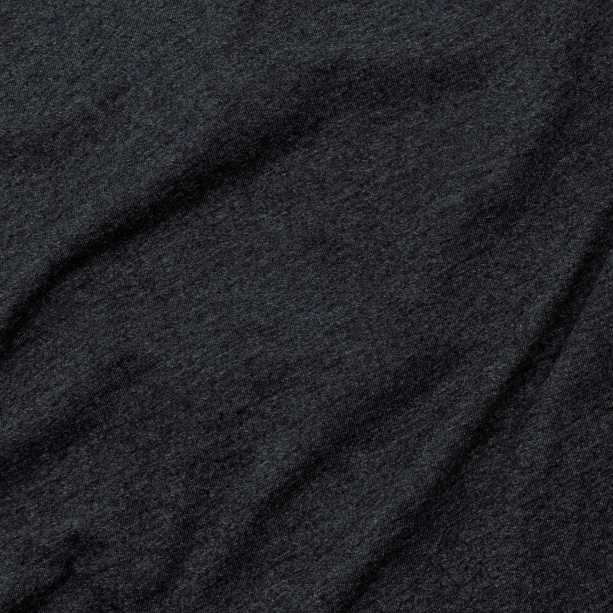 Charcoal gray T-shirt fabric close-up with heather texture.