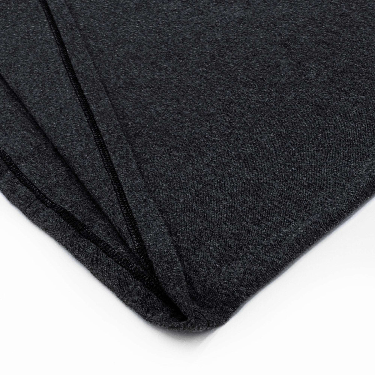 Charcoal gray T-shirt side seam and bottom hem detail.