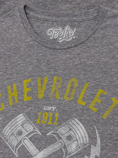 Gray T-shirt neckline with white Tee Luv logo and yellow Chevrolet graphic text