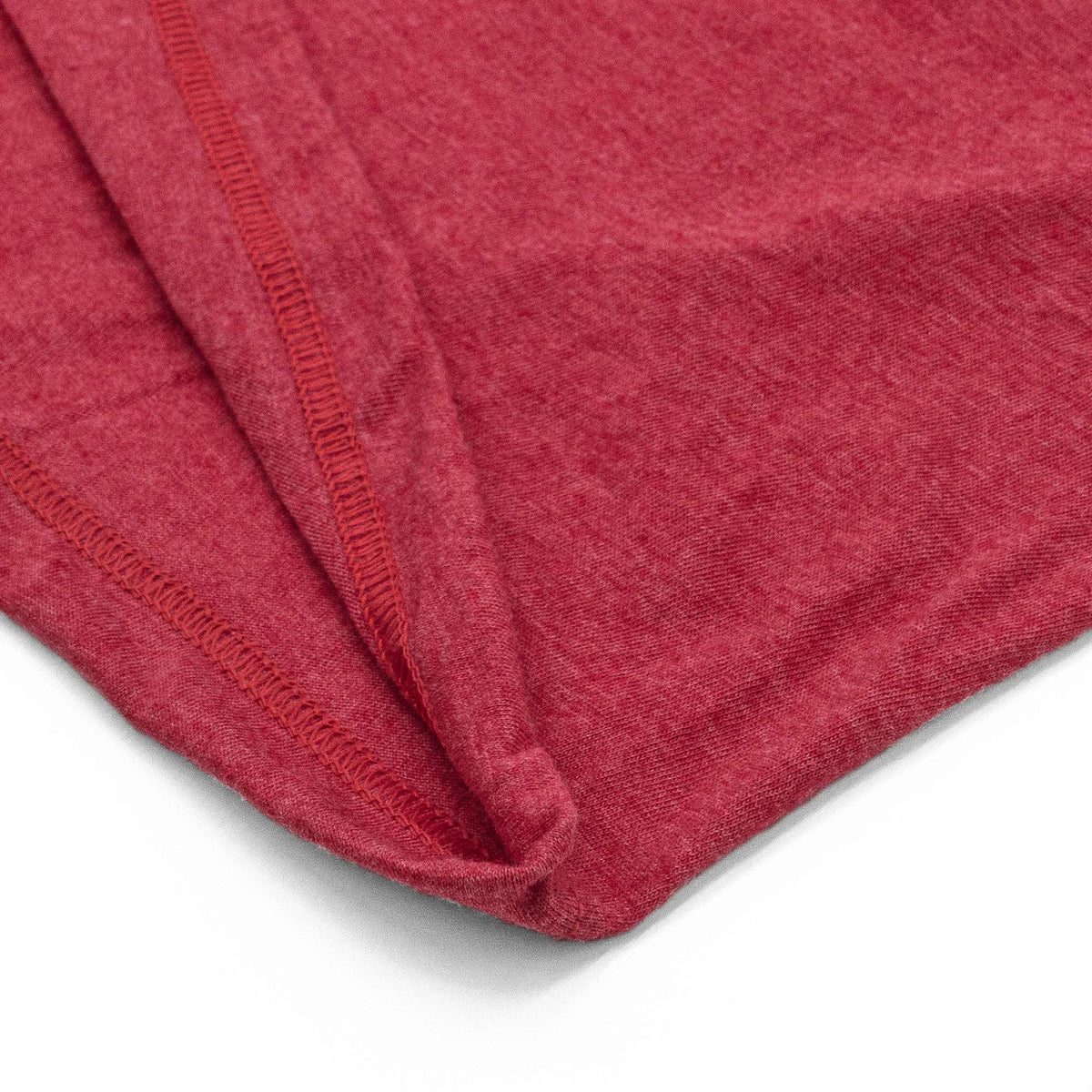 Red T-shirt fabric fold with stitched seams close-up