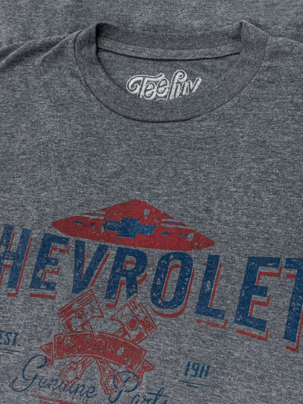 Gray T-shirt close-up of CHEVROLET lettering and red emblem graphic