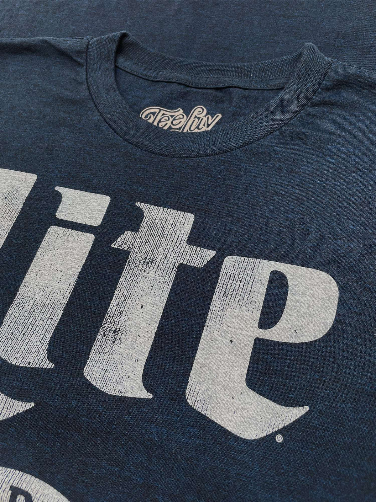 Dark navy LITE logo graphic T-shirt front close-up with Tee Luv label at collar