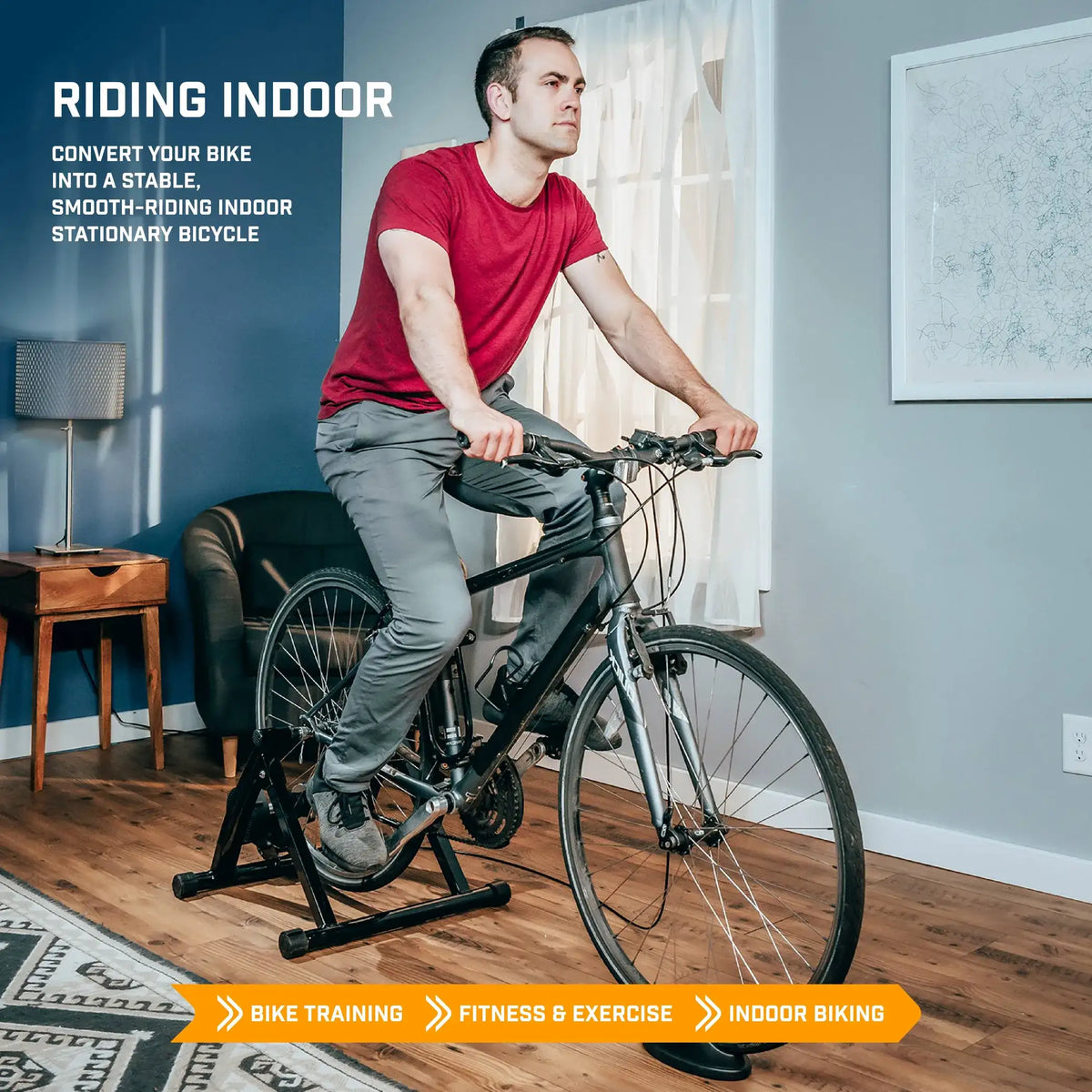 Cyclist using magnetic bike trainer stand with road bicycle in indoor riding position