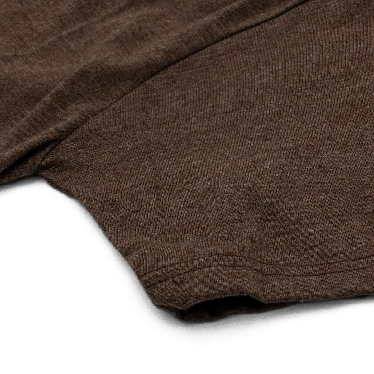 Brown heather T-shirt showing sleeve hem and curved bottom hem