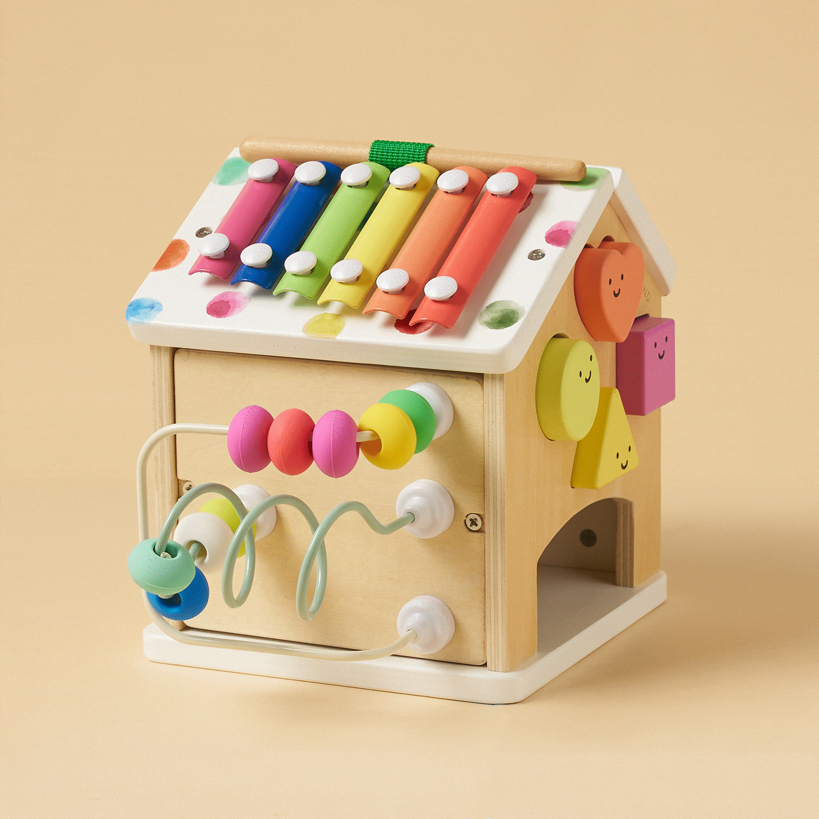 Wooden cottage activity cube with rainbow xylophone top, bead maze, and knob features