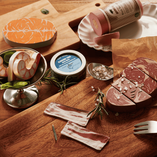Wooden sliced meat and seafood play food pieces with wrapped rolls and tin