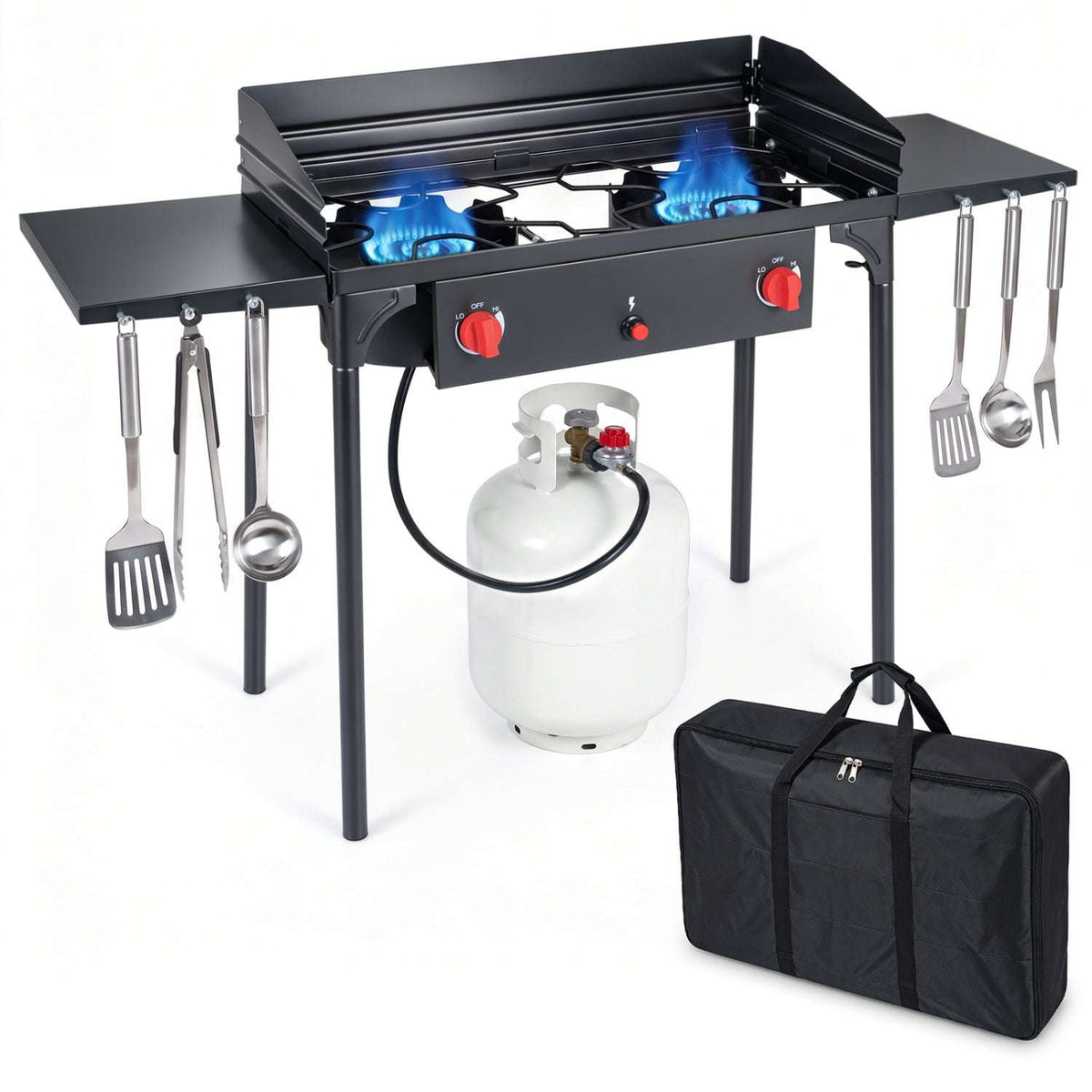 Two-burner propane stove with blue flames, cooking tools, tank, and carry bag