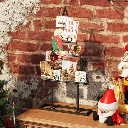 Black metal Christmas tree photo holder displaying family photos and holiday cards.