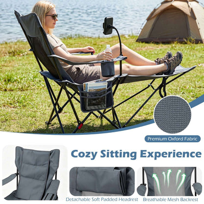 Grey reclining camping chair with extended footrest, padded headrest and mesh back