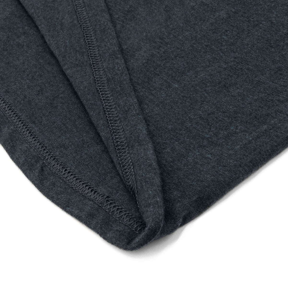 Blue T-shirt hem corner close-up showing stitched edge