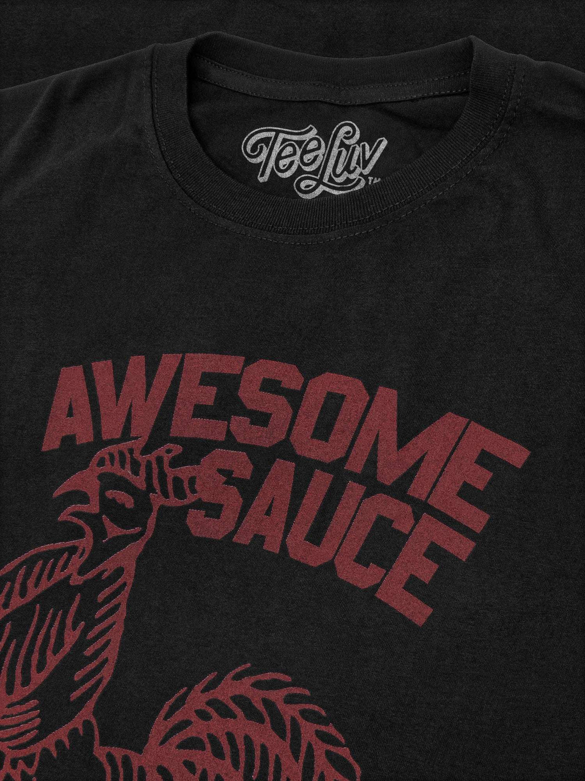 Black T-shirt closeup: red “AWESOME SAUCE” text with rooster graphic