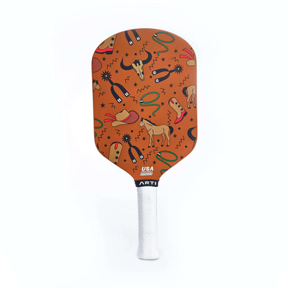 Orange patterned pickleball paddle face with USA mark and white grip