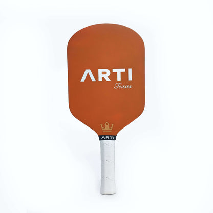 Orange back of pickleball paddle with ARTI Texas logo and white handle