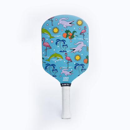 Blue pickleball paddle with illustrated face and white grip handle
