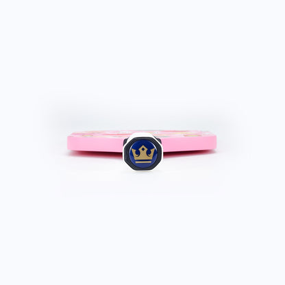 Pink pickleball paddle side with blue emblem on the edge and white grip