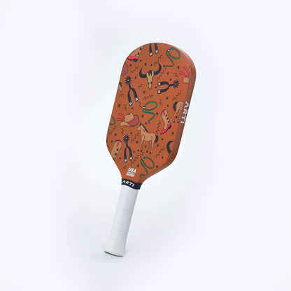Orange Texas-themed pickleball paddle with patterned face and white grip