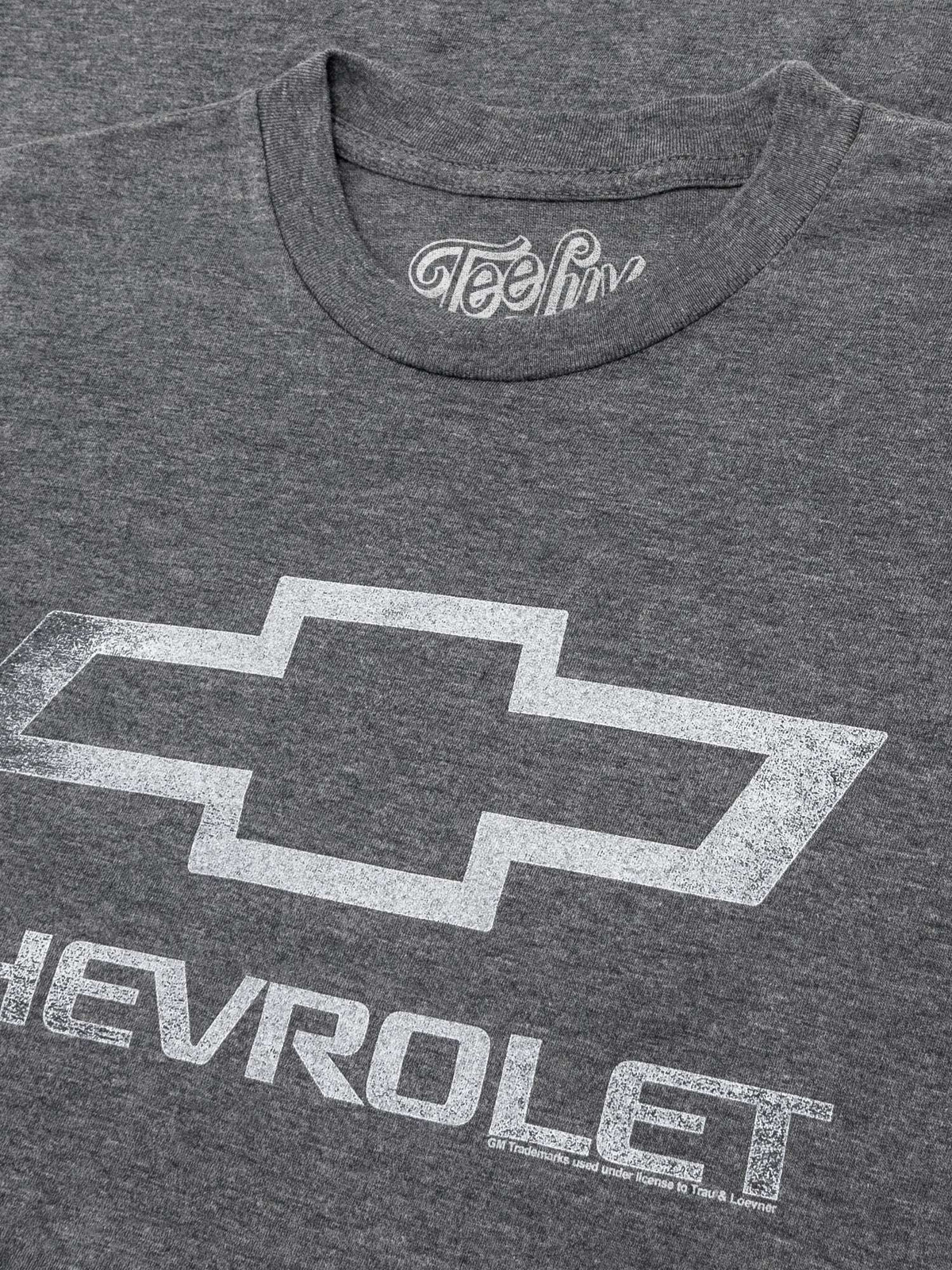 Gray T-shirt close-up of Chevrolet bowtie logo with CHERVEROLET lettering