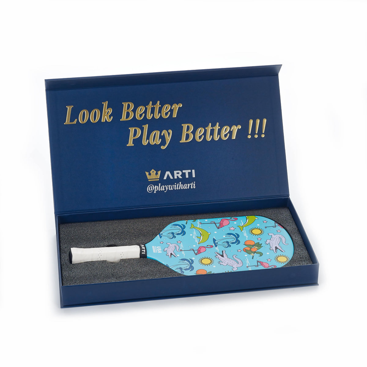 ARTI blue pickleball paddle in box, patterned face and dark handle grip