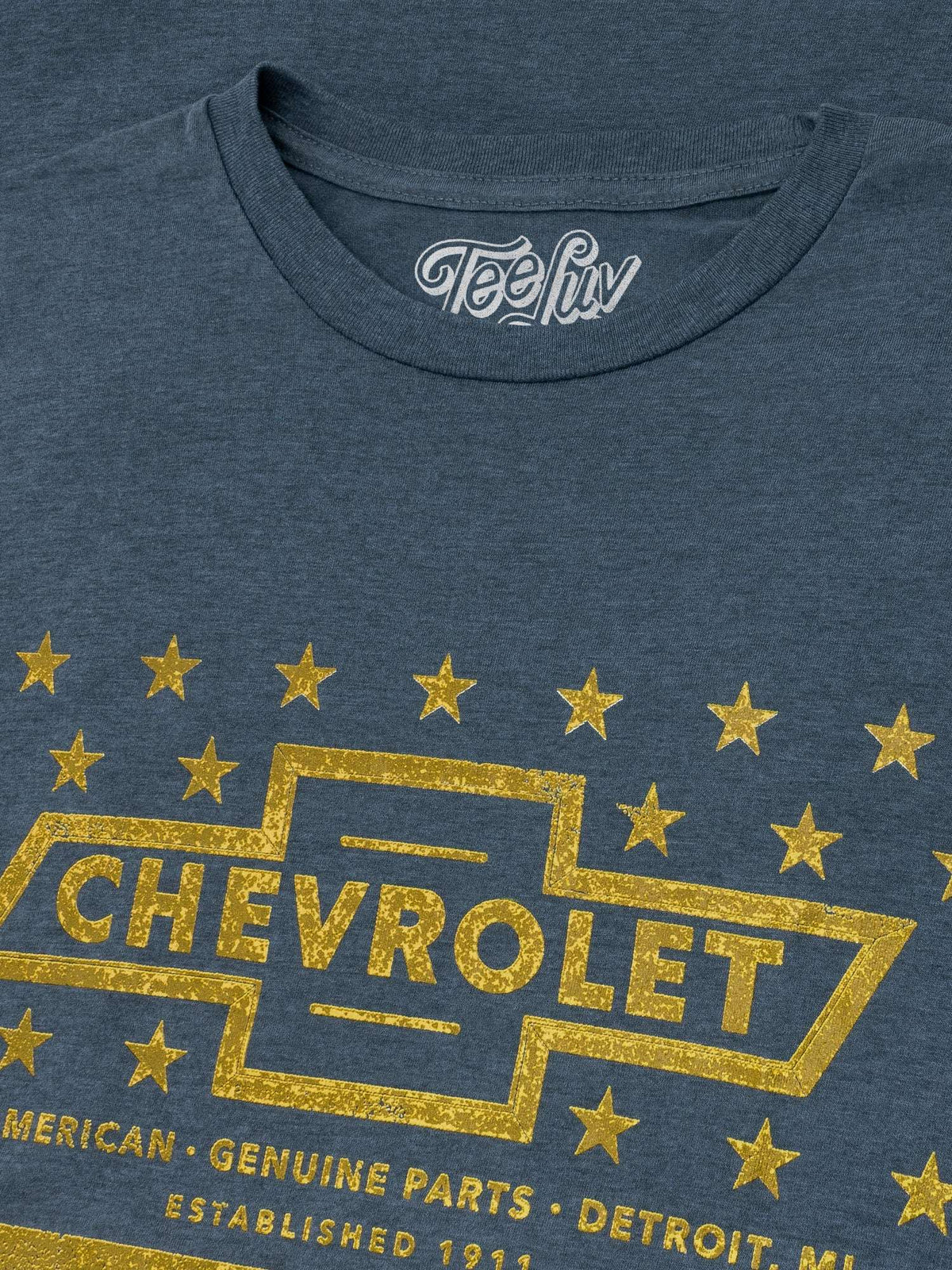 Gray heather T-shirt close-up of gold Chevrolet emblem with stars