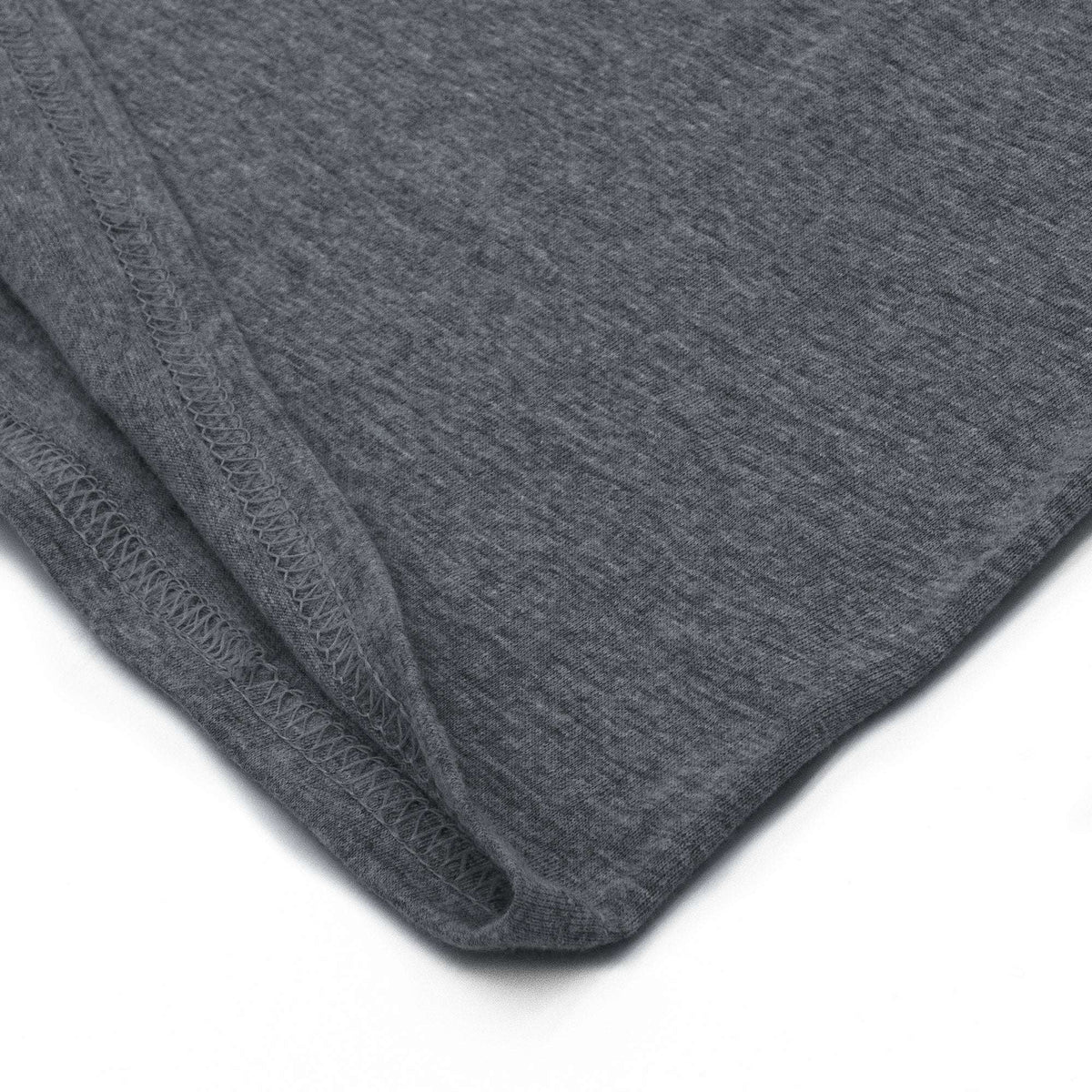 Gray t-shirt bottom hem stitching detail on knit fabric.