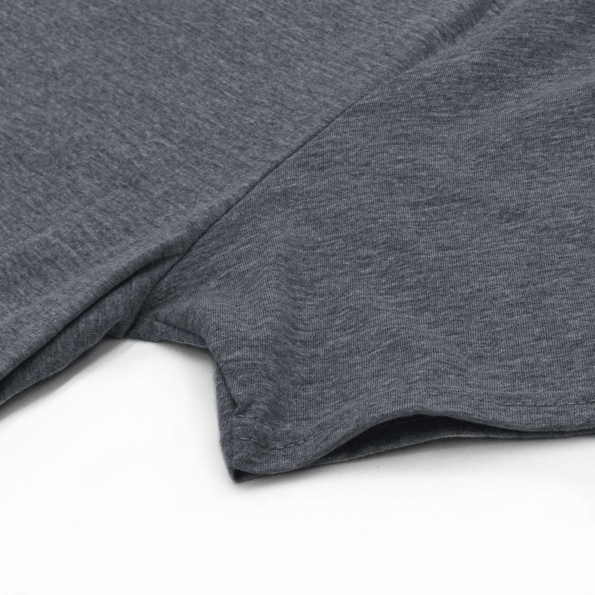 Gray t-shirt sleeve and hem detail, showing soft knit fabric.