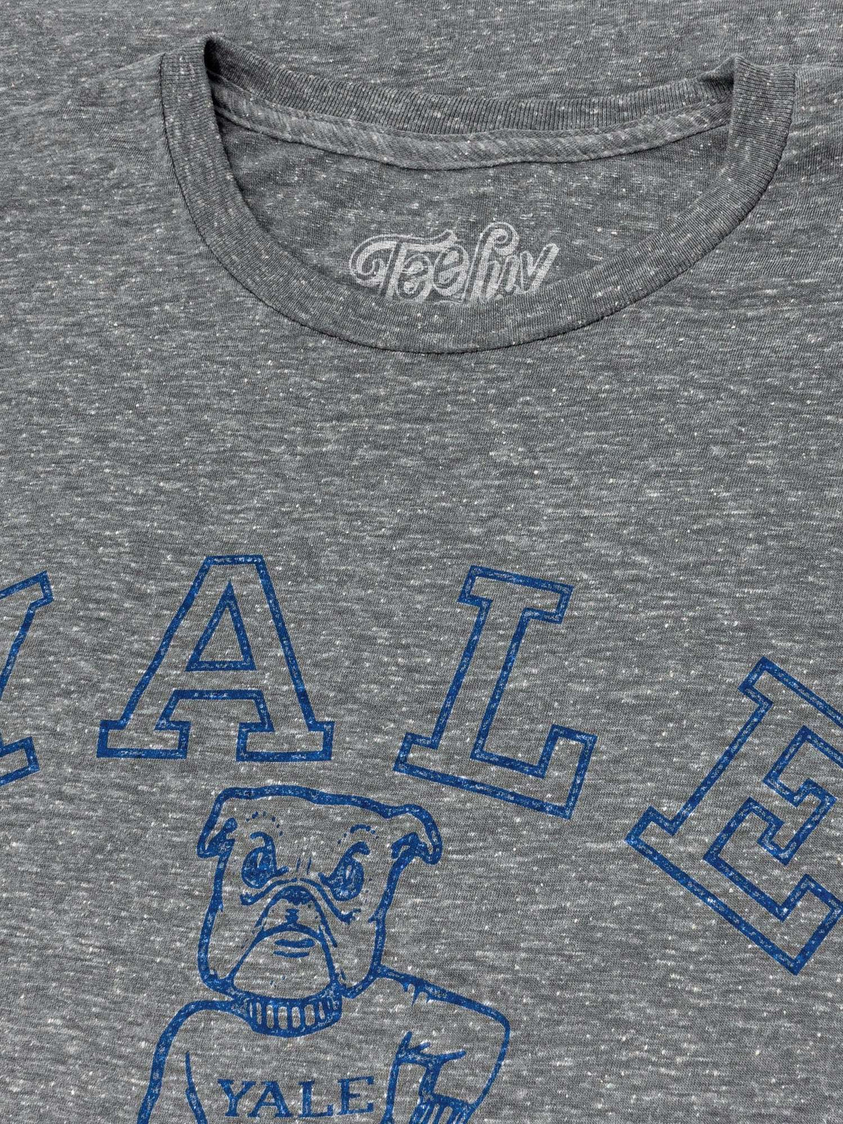 Gray T-shirt neckline with partial blue Yale logo and bulldog graphic
