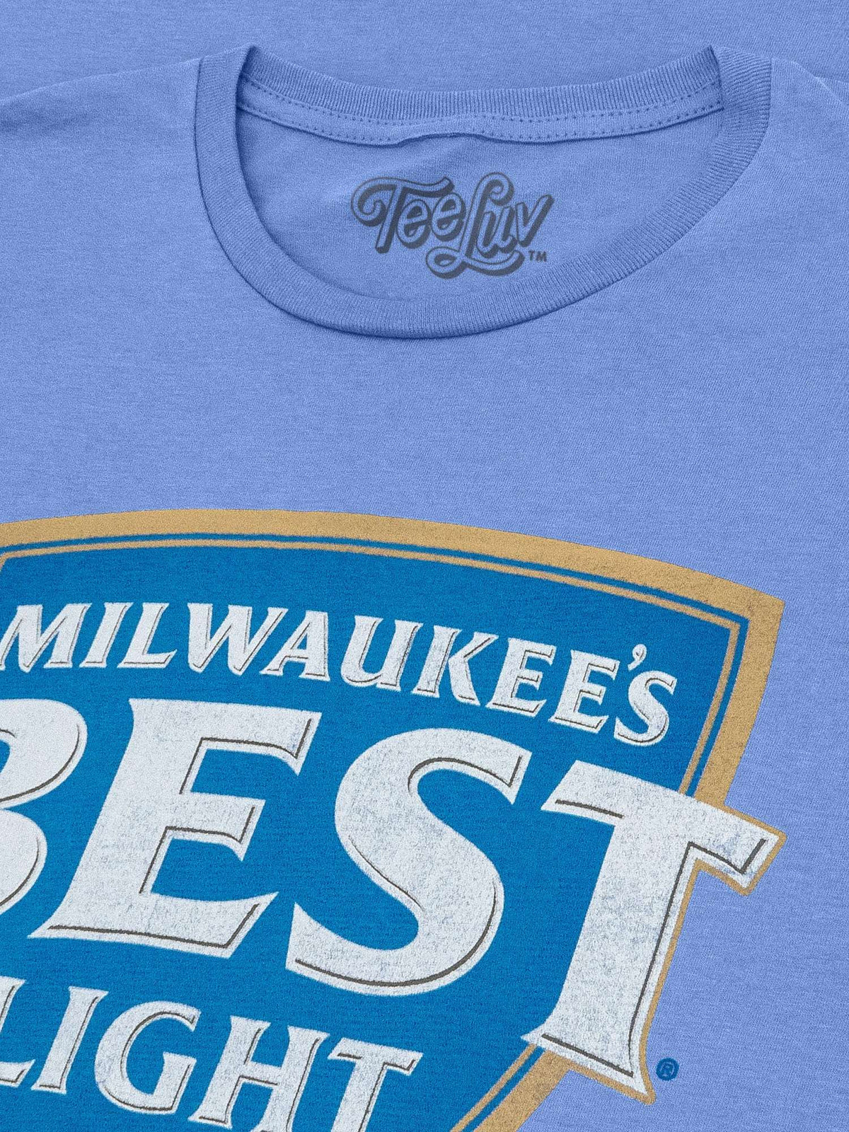 Light blue heather T-shirt collar and partial Milwaukee's Best Light logo graphic