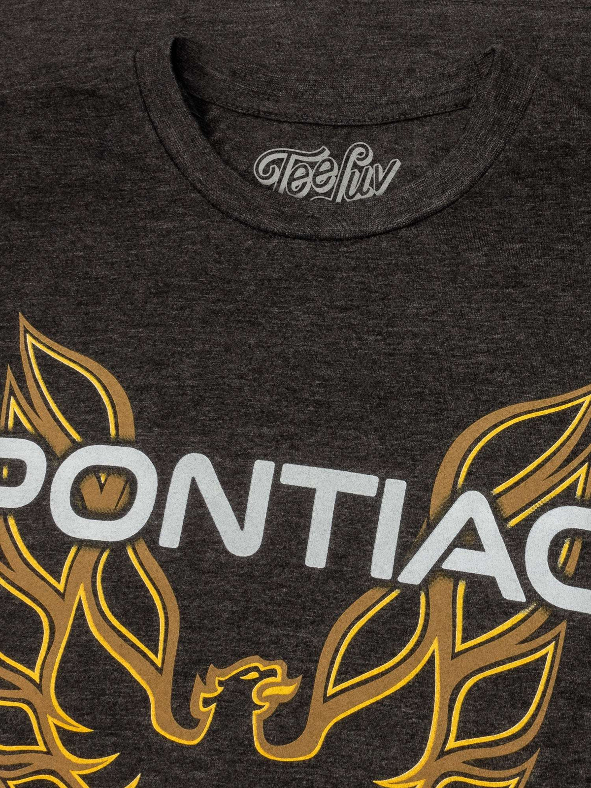 Dark heather gray T-shirt close-up of Pontiac text with yellow flame wing graphics