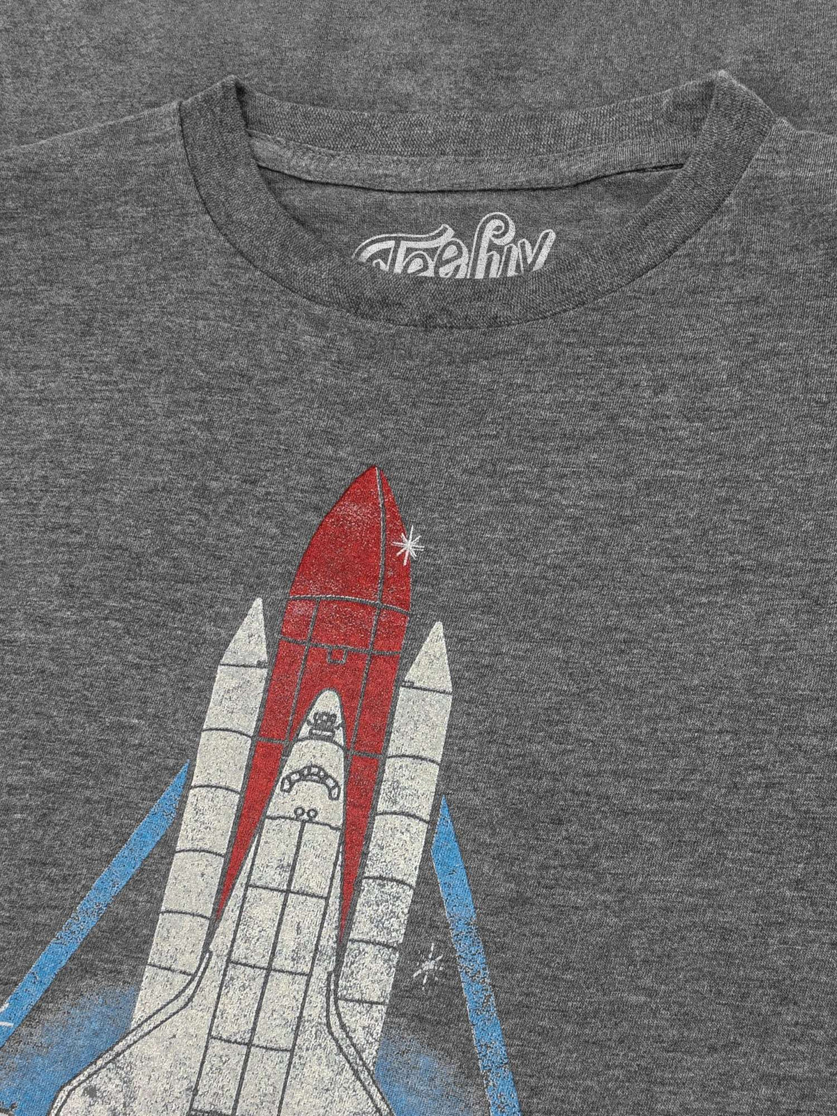 Gray t-shirt close-up of red-and-white space shuttle graphic