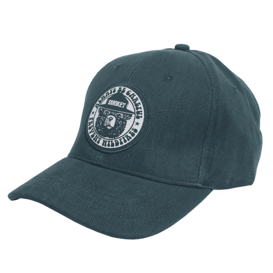 Forest green embroidered baseball cap with circular Smokey Bear patch at front