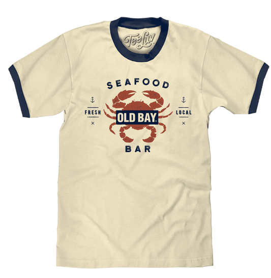 Beige ringer T-shirt with distressed Old Bay Seafood Bar logo and navy trim