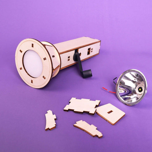 DIY hand-crank flashlight kit with wooden crank body, lens reflector, and cut parts