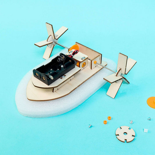 Paddlewheel boat DIY kit showing assembled hull, motor box, and four paddle fins