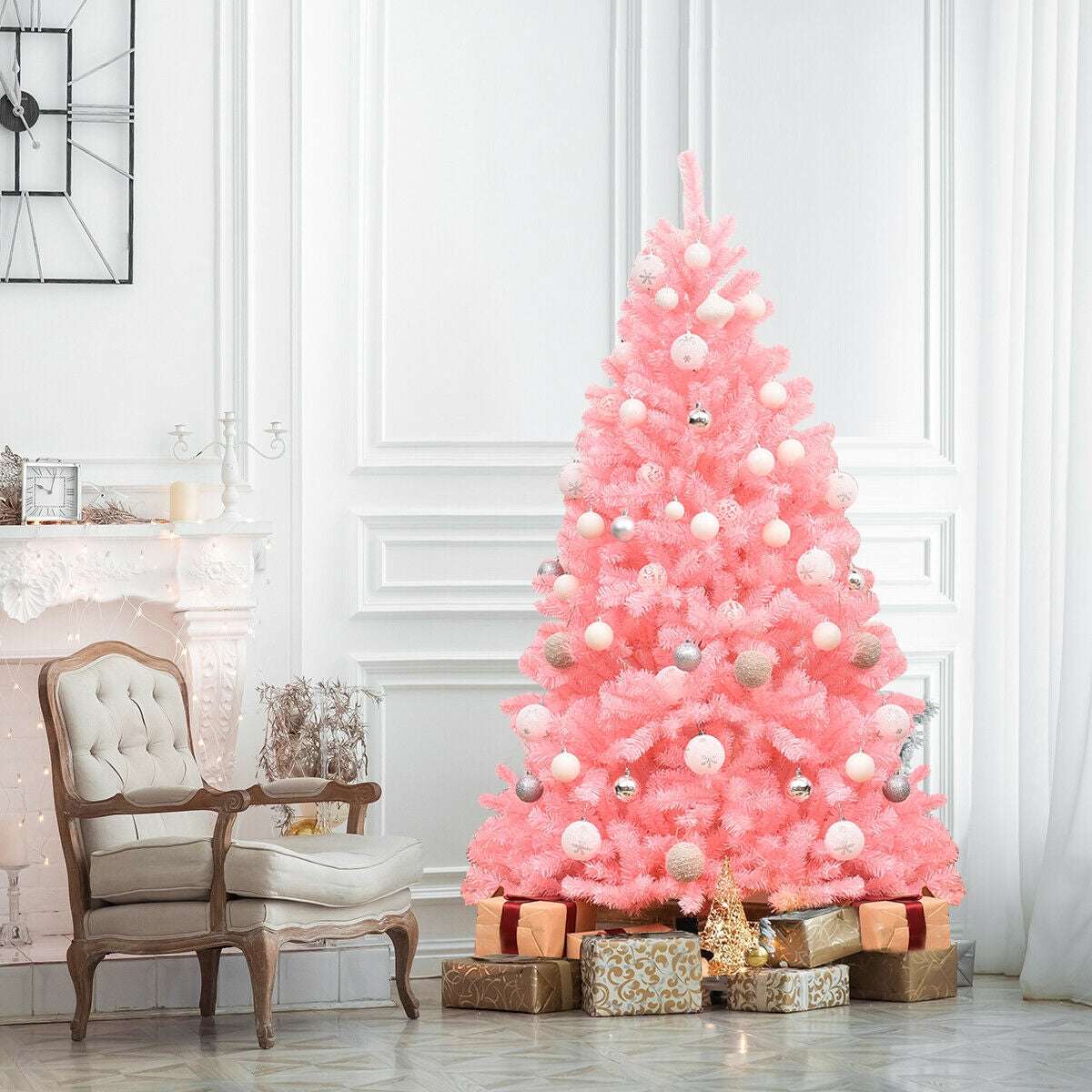 Decorated pink artificial Christmas tree with white and silver ornaments