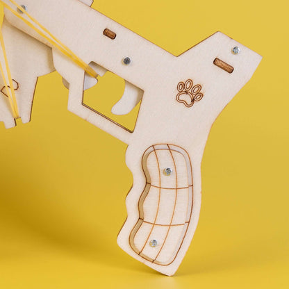 Wooden launcher gun part with paw emblem, trigger guard, and lanyard strap