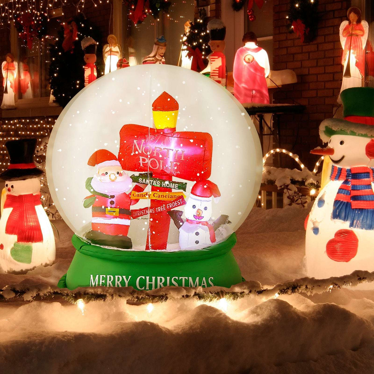 Inflatable Christmas snow globe with Santa, snowman, North Pole sign, and green base