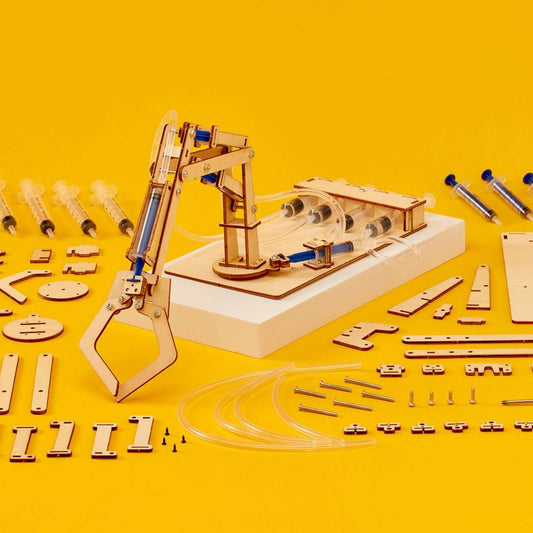 Hydraulic robotic arm STEM kit on white base, with blue and clear cylinder components