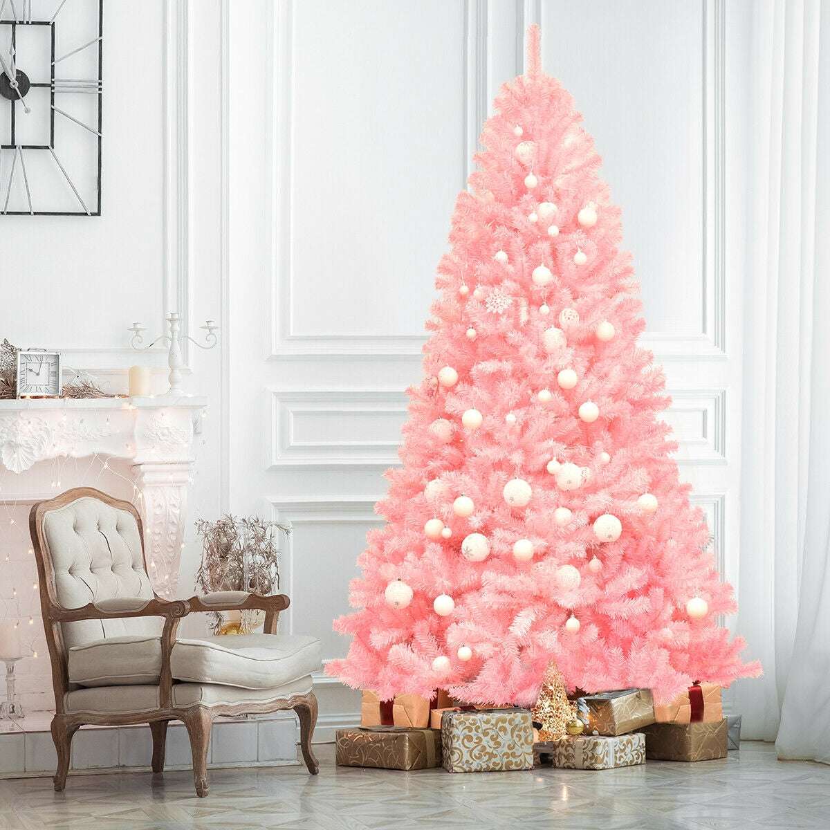Pink artificial Christmas tree decorated with white ornaments