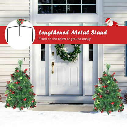 Pair of decorated Christmas trees with metal stands, shown flanking an entrance