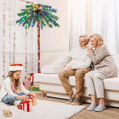 Six-foot artificial palm Christmas tree with multicolor lights on its fronds and trunk