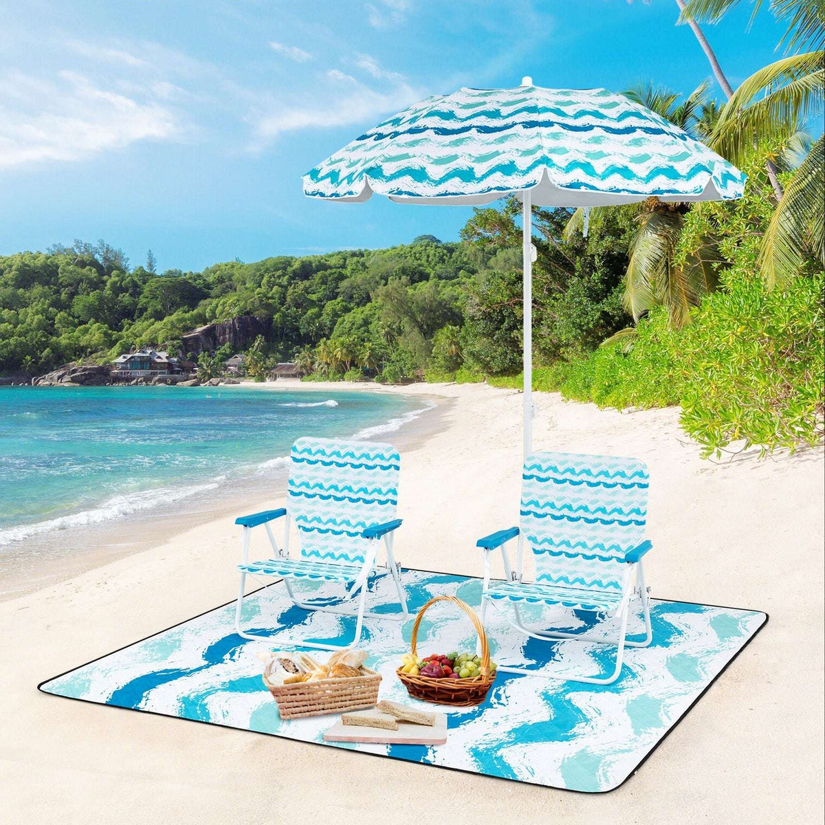 Blue umbrella with two striped chairs and picnic blanket on the beach