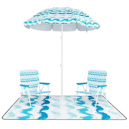 Blue striped umbrella with two foldable chairs and matching picnic blanket