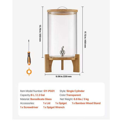 Clear tall glass beverage dispenser on bamboo stand with metal spigot and lid loop