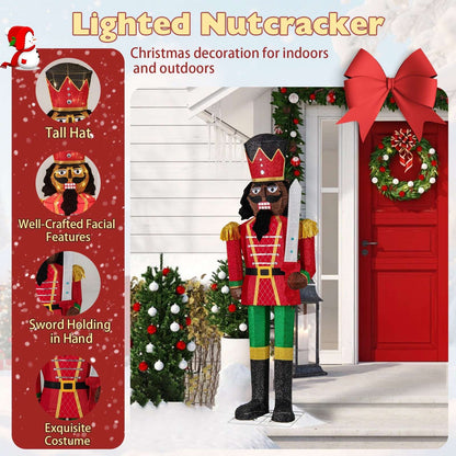 Lighted Christmas nutcracker with tall crown hat, red coat, and sword in hand