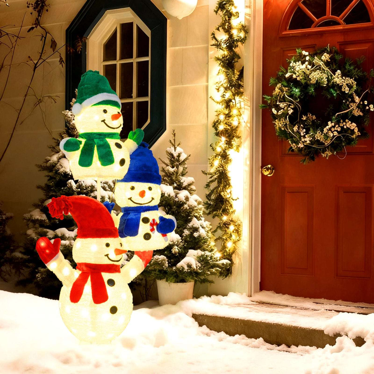 Three stacked lighted snowmen in red, blue, and green hats and scarves