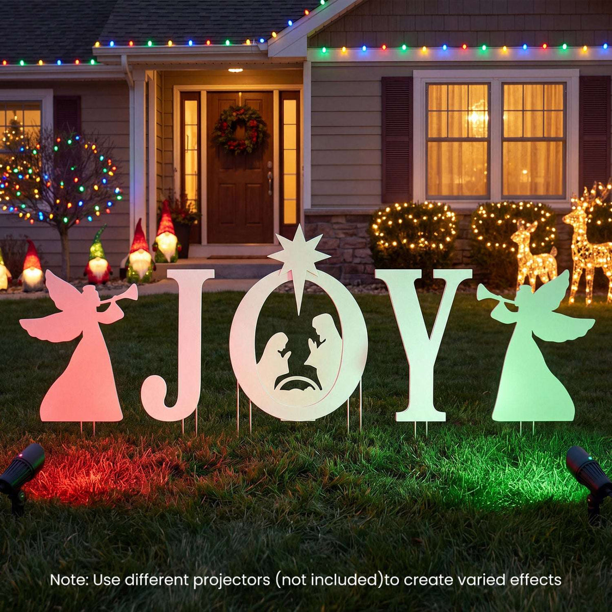 Five-piece JOY nativity yard sign set with angel figures and a star, shown with colored lighting