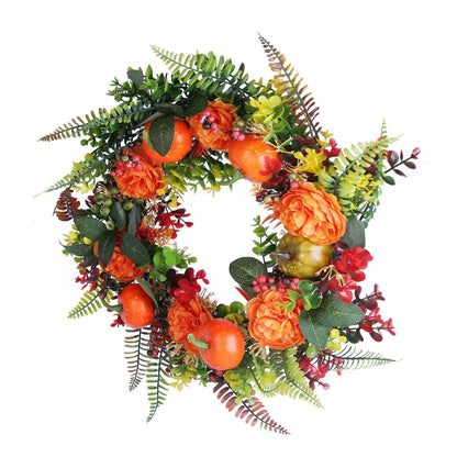 Autumn wreath with faux pumpkins, orange roses, red berries, and textured green leaves
