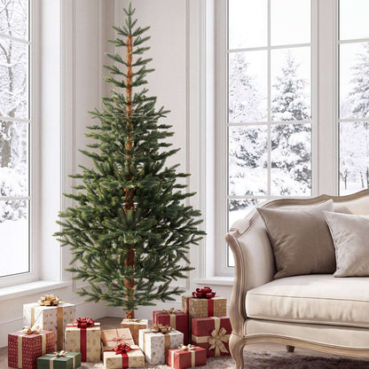 Unlit artificial Christmas tree with sparse green branches and a visible brown trunk