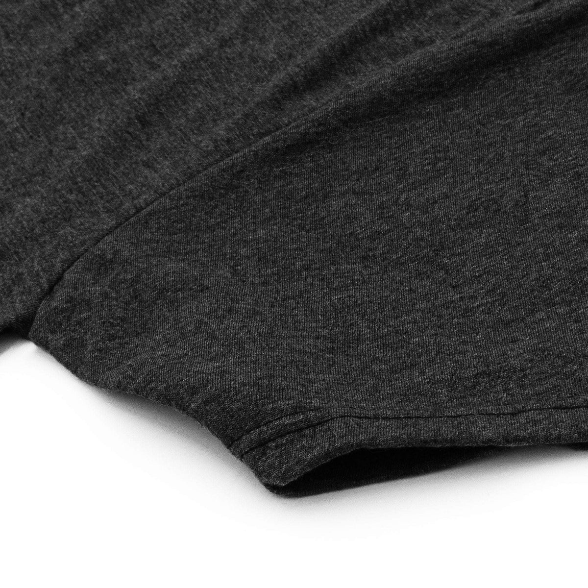 Charcoal short-sleeve T-shirt showing curved hem and folded fabric edge