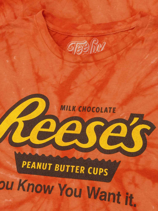 Orange tie-dye T-shirt close-up with Reese's logo and “You Know You Want It.”